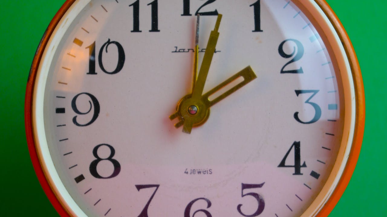 An hourglass running out of sand, with digital keys inside instead of grains.